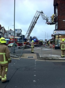 Firefighters make a wind-damaged cast iron drainpipe safe