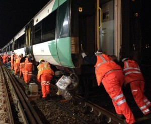 Rail workers right a derailed train at Brighton
