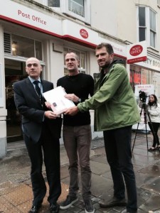 John Taylor poses with the petition to save the Brunswick Town Crown Post Office in Western Road, Hove, with Peter Kyle MP and ward councillor Ollie Sykes