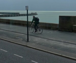 A cyclist riding on the pavement near Brighton Marina by John Keogh on Flckr